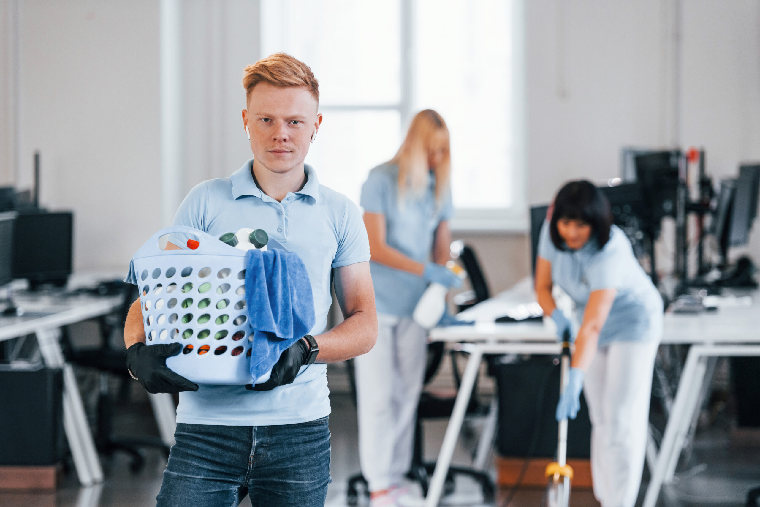 man-holds-basket-group-workers-clean-modern-office-together-daytime.jpg